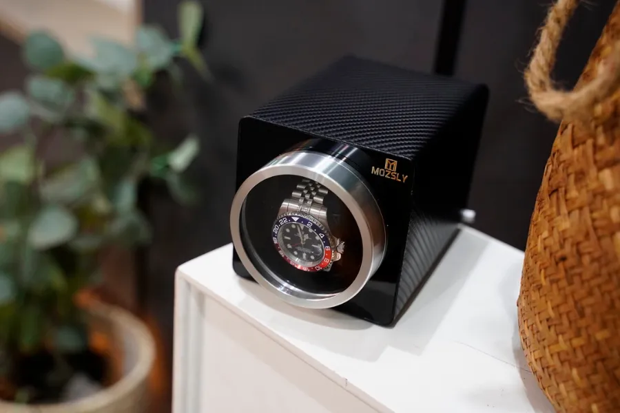 A Mozsly watch winder with watch inside safely
